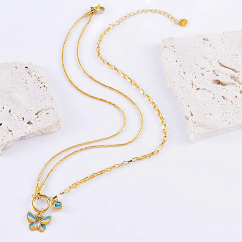 Gold titanium steel jewellery set with colourful epoxy butterfly pendant necklace and matching bracelet