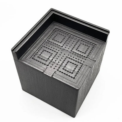 Set of four round black plastic furniture risers, each 3cm tall, on a wooden floor.