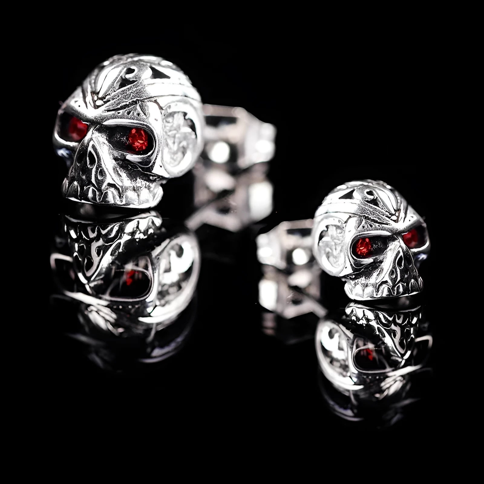 Red eye skull stud earrings with electroplated alloy construction and gemstone accents