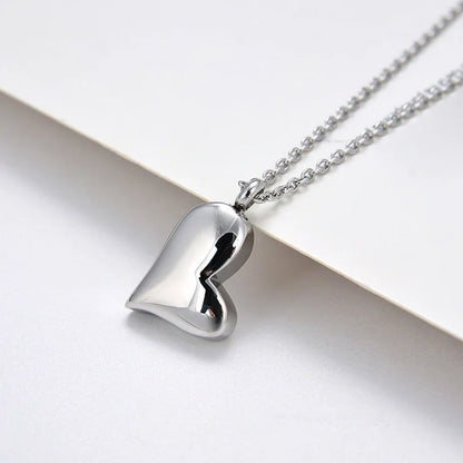 Silver curved peach heart pendant on stainless steel chain with adjustable length