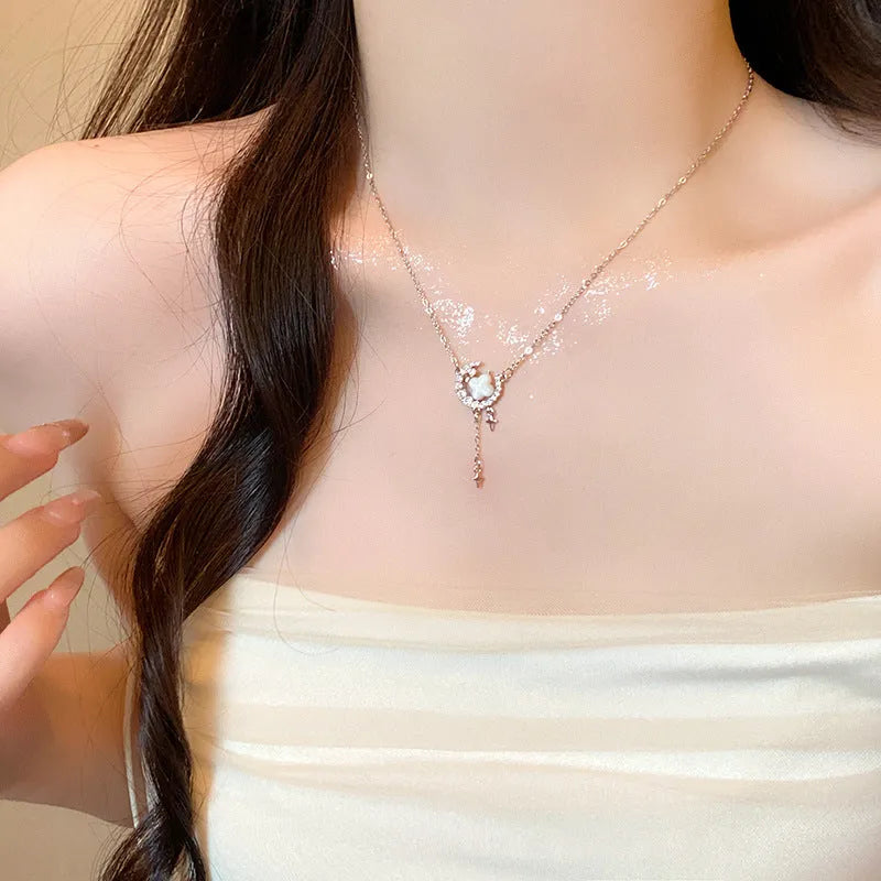 Women's sparking zirconium necklace showing star and moon pendant on adjustable chain