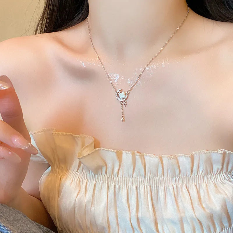 Women's sparking zirconium necklace showing star and moon pendant on adjustable chain