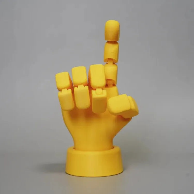 Yellow movable joint hand ornament showing articulated fingers and wrist joints