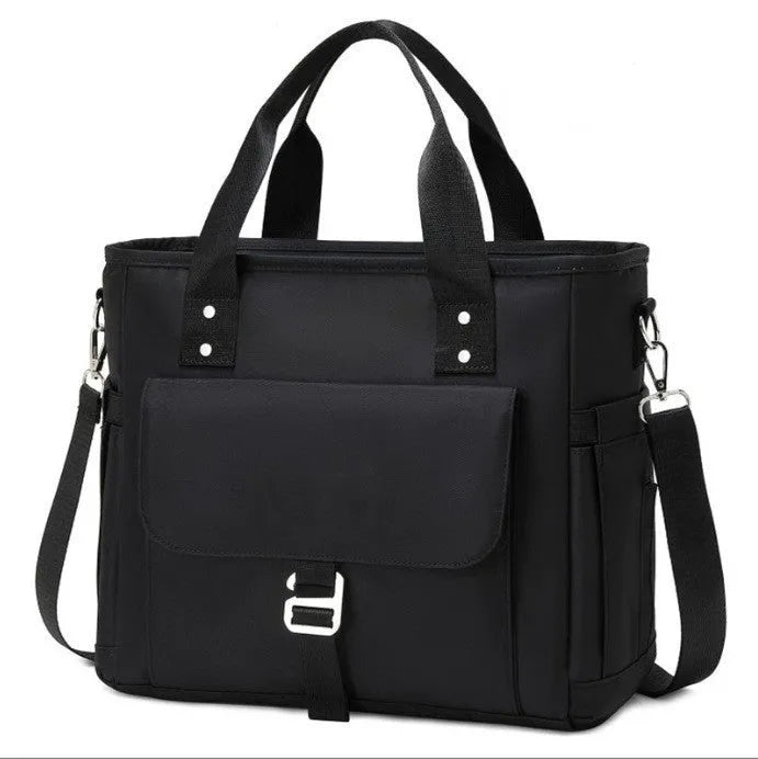 Insulated cube-shaped picnic bag with a removable shoulder strap in pink, shown with a side pocket.