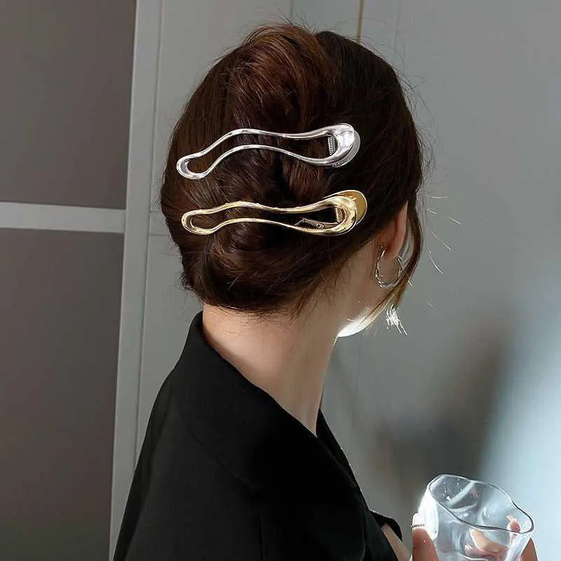 Women's gold and silver zinc alloy hair barrettes in arc, square, and triangle shapes.