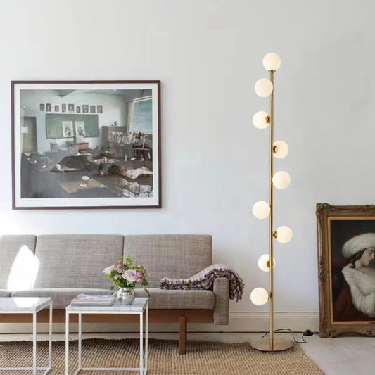 Minimalist floor lamp with wrought iron base and glass elements, 154cm tall with 23cm diameter