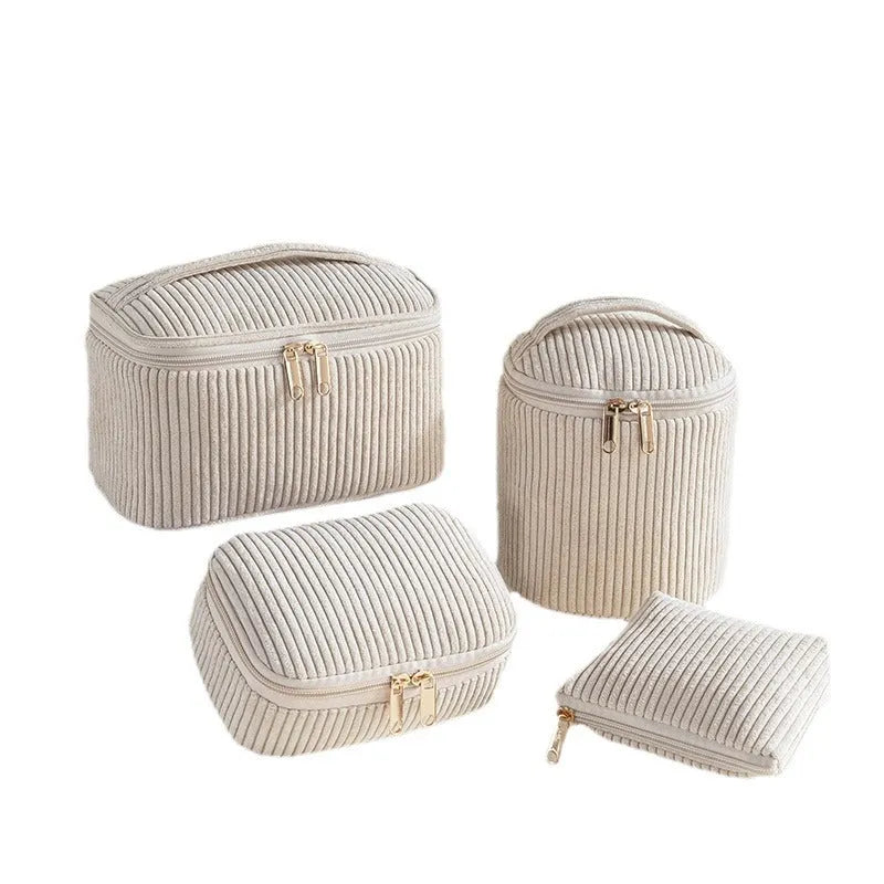 Four cube-style flannelette makeup bags in pink, khaki, pink dots, and blue with dots colours showing compartment organisation