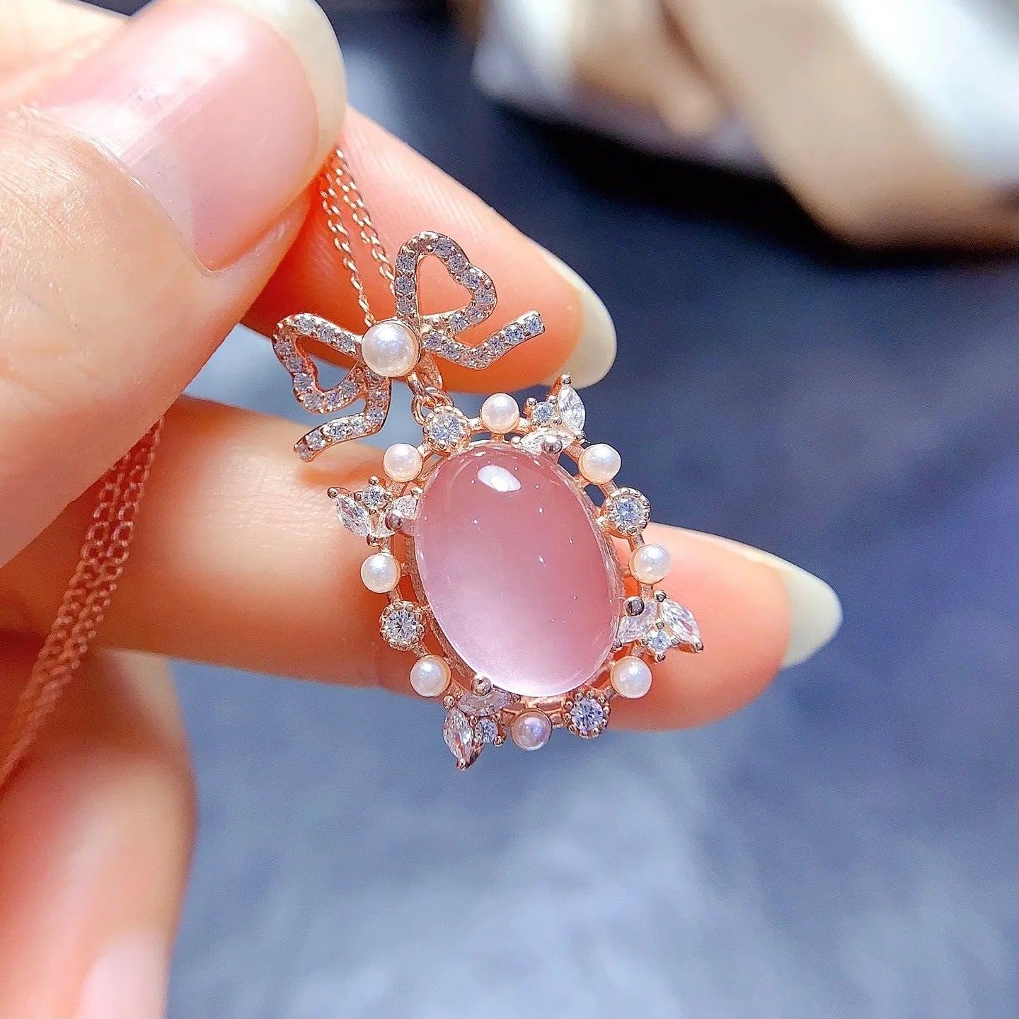 Geometric rose quartz pendant necklace on sterling silver chain with rose gold plating.