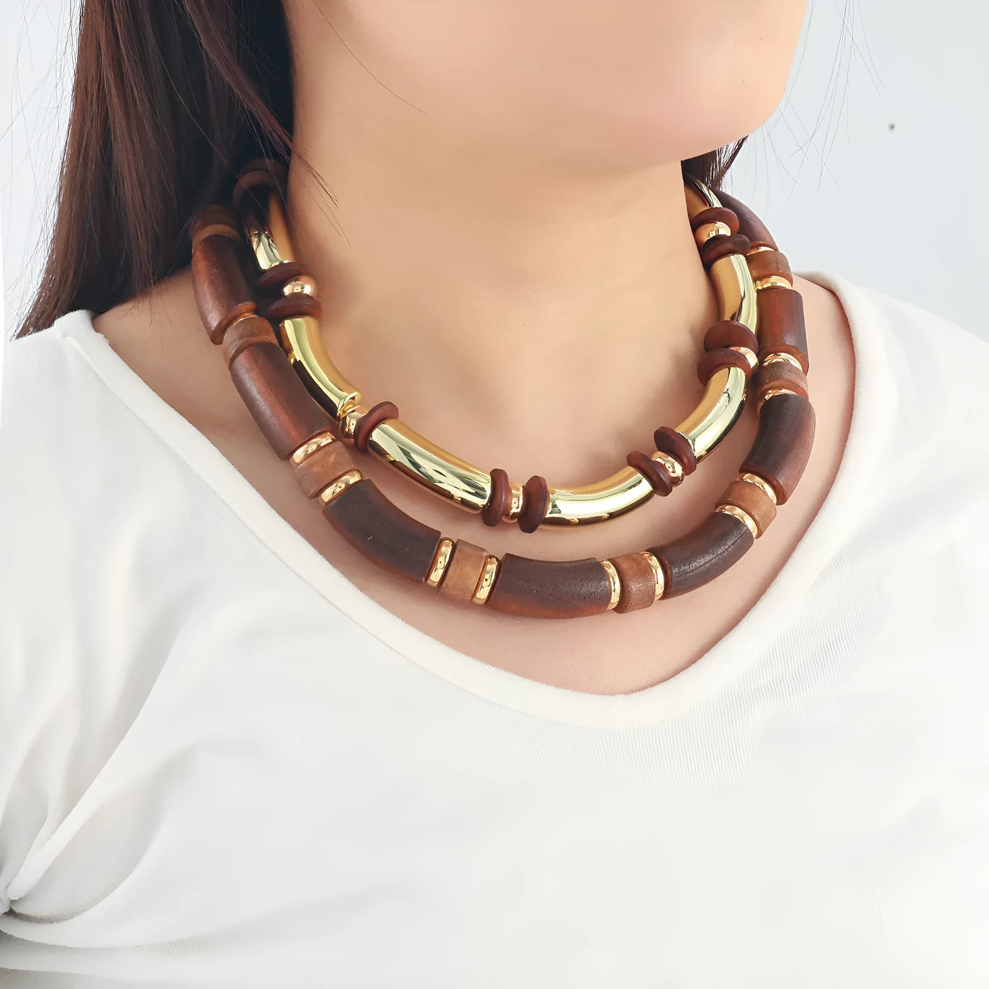 Women's exaggerated multi-layer wooden bead necklace and matching alloy bracelet set on a white background