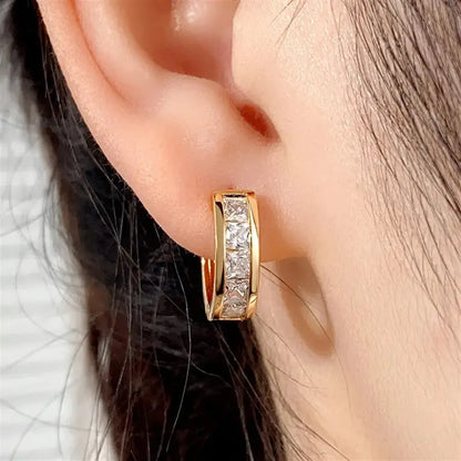 Geometric quadrilateral earrings in gold or silver plating, showing structured design and smooth surface finish