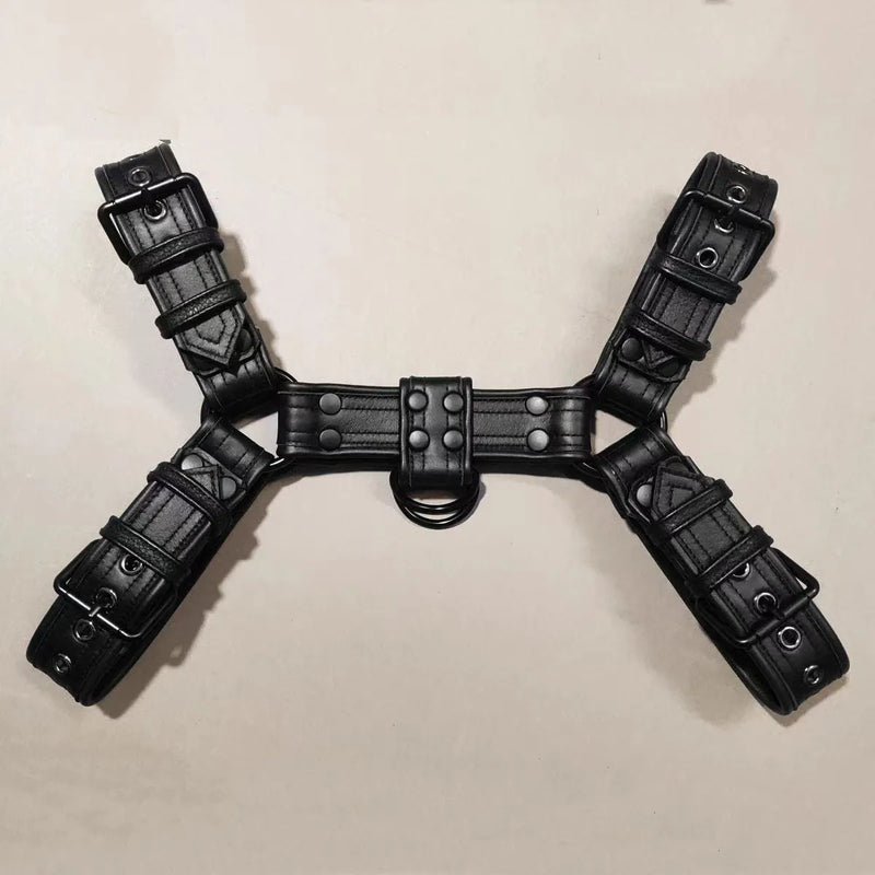 Leather chest muscle bondage adjustable shoulder strap for men, featuring metal buckle fastenings with riveted leather construction in black, suitable for adult party wear and costume use.
