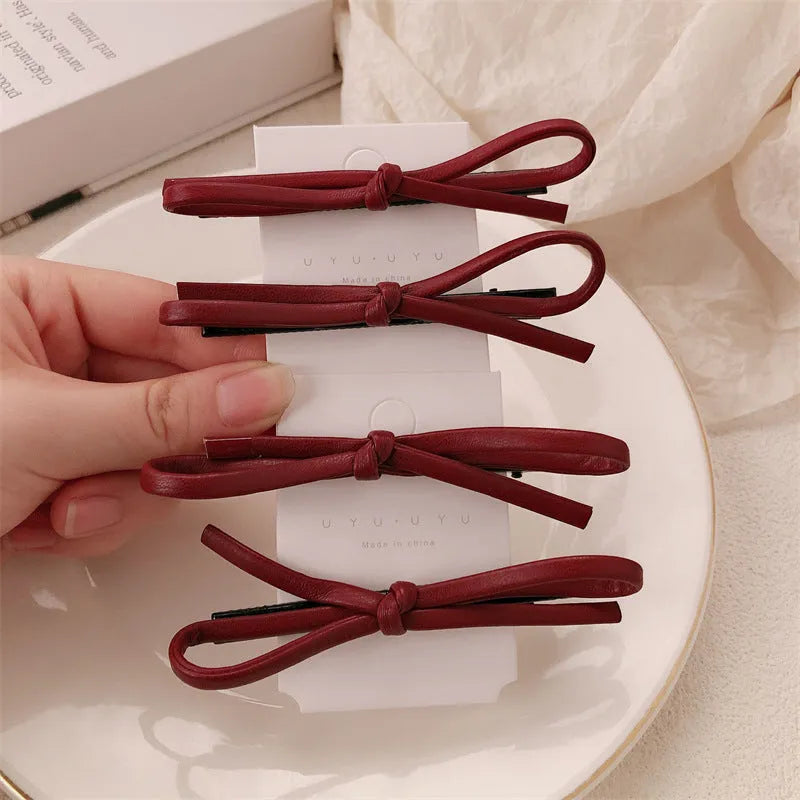 Wine red leather bow hair barrette with 2.5cm bow width and 5cm clip length