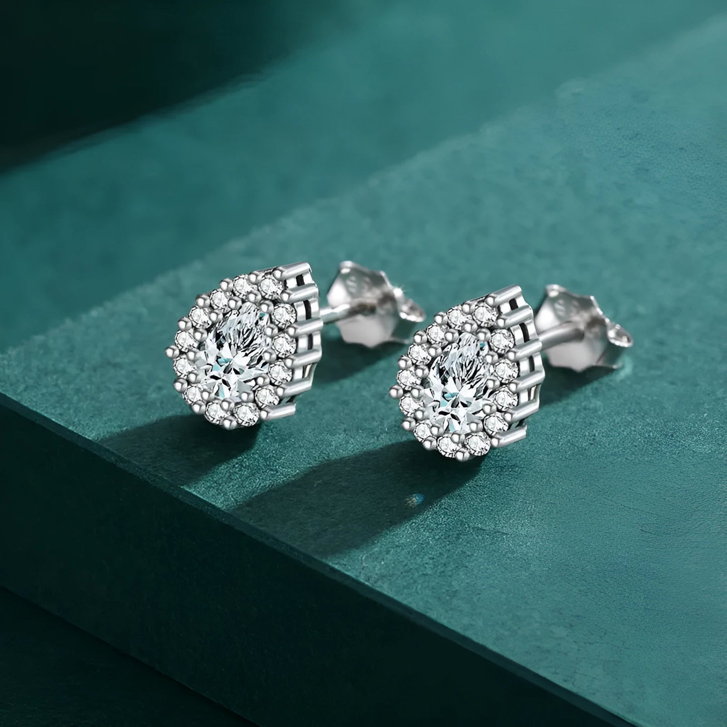A pair of women's silver drop-shaped ear studs with a polished finish on a white background.