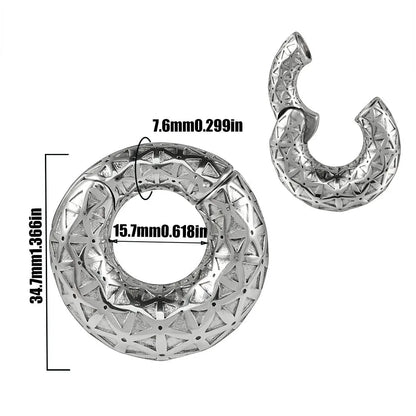 A pair of stainless steel fashion earrings featuring a totem pattern design in an electroplated colour.