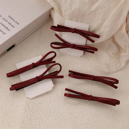 Wine red leather bow hair barrette with 2.5cm bow width and 5cm clip length