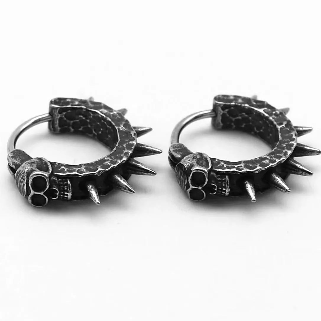 A pair of black vintage-style dangle earrings shaped like detailed motorcycles with a copper tone, on a white background.
