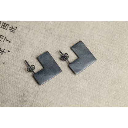 Oxidised black sterling silver earrings with a geometric square shape and minimalist ring design.