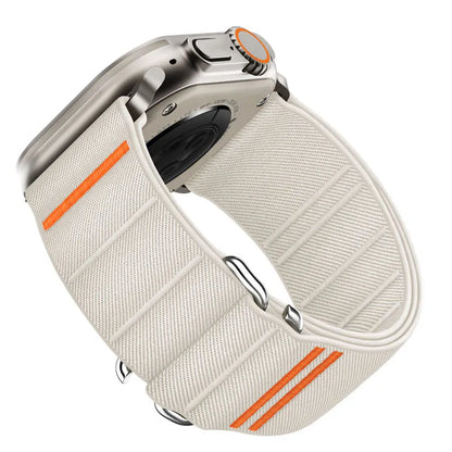Elastic nylon Apple Watch band in Army Green with stainless steel buckle, shown on a wrist.