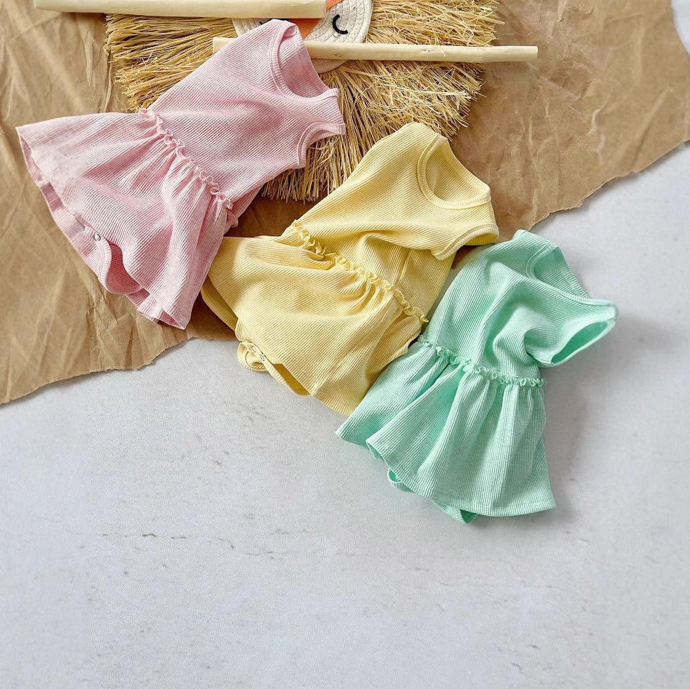 Baby girl wearing pink sleeveless vest onesie with waffle cotton texture and single-breasted closure