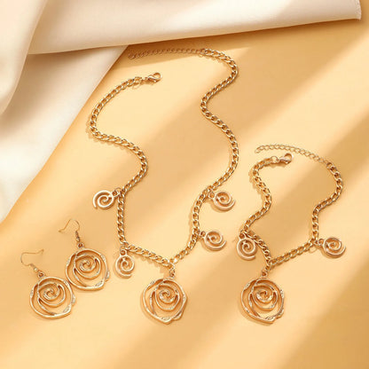 Gold spiral donut alloy jewellery set showing necklace, bracelet, and ear hooks on a plain background.