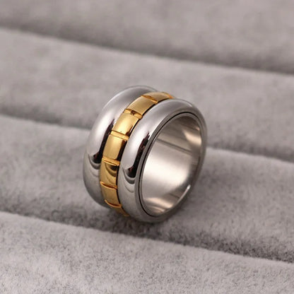 Gold ultra-wide titanium steel men's ring with a rotatable tail component on a finger.