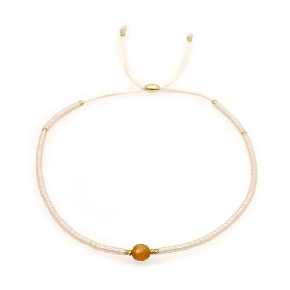 Handmade women's bracelet with colourful geometric glass and coloured glaze beads in Bohemian style.