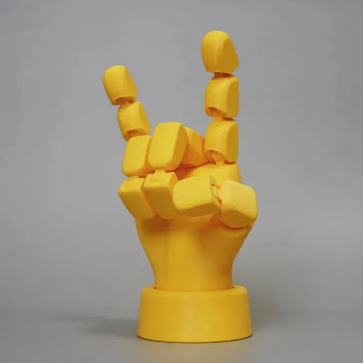 Yellow movable joint hand ornament showing articulated fingers and wrist joints