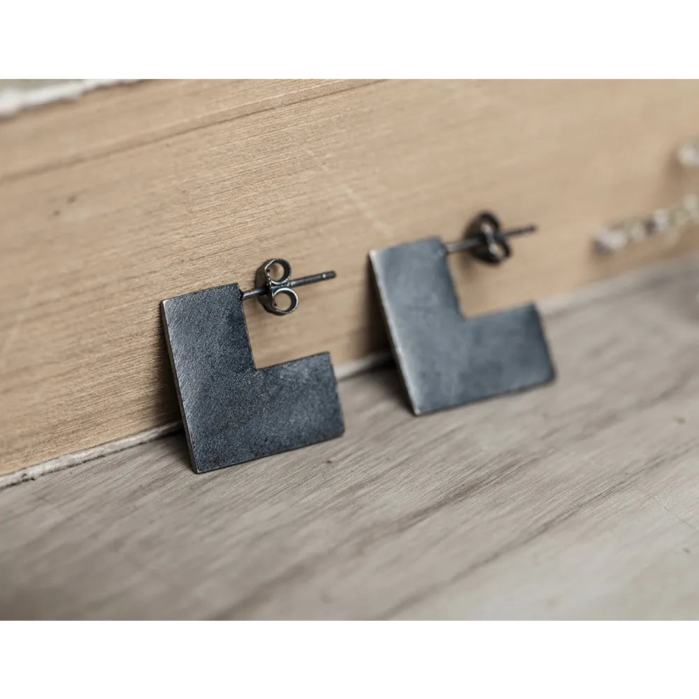 Oxidised black sterling silver earrings with a geometric square shape and minimalist ring design.