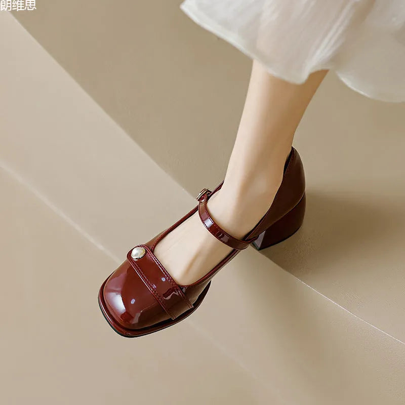 Women's apricot patent leather chunky heel ankle strap pumps with a square toe on a white background