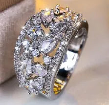Women's round hollow copper ring showing gold and platinum plating options with sapphire blue and white accents