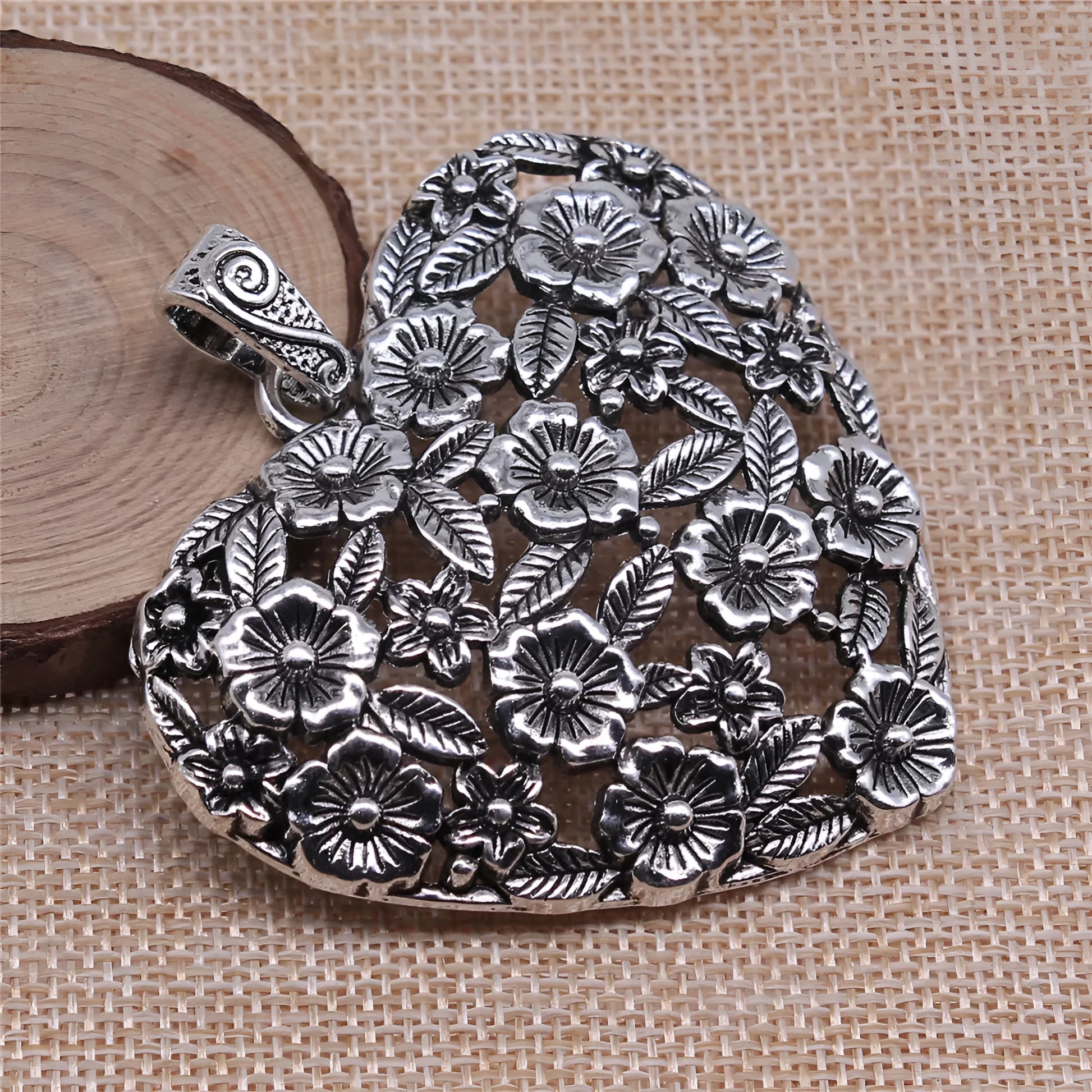 Ancient silver hollow flower love alloy pendant measuring 67mm by 58mm