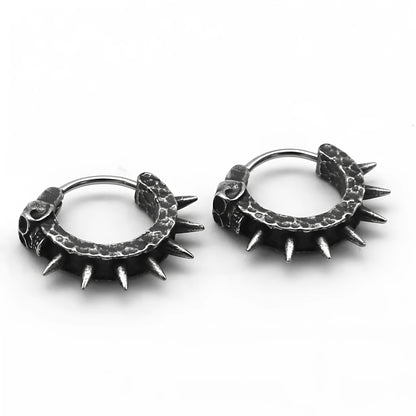 A pair of black vintage-style dangle earrings shaped like detailed motorcycles with a copper tone, on a white background.