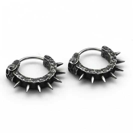 A pair of black vintage-style dangle earrings shaped like detailed motorcycles with a copper tone, on a white background.