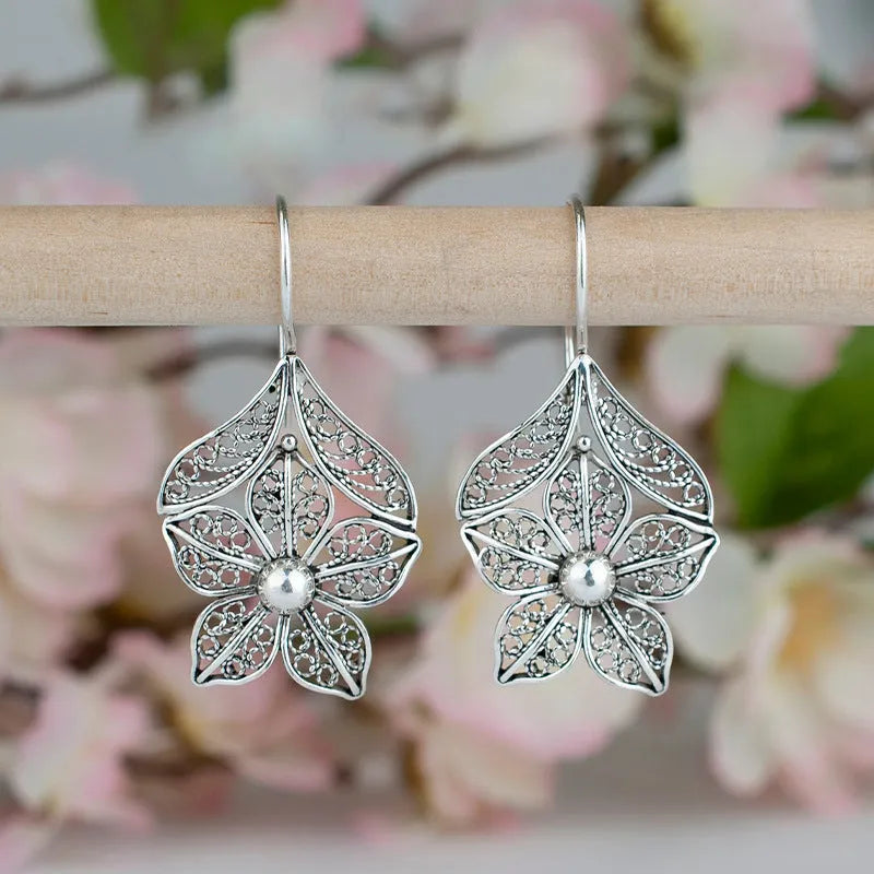 Silver hollow flower leaf-shaped alloy earrings with openwork floral detailing