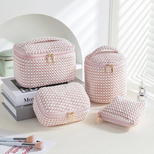 Four cube-style flannelette makeup bags in pink, khaki, pink dots, and blue with dots colours showing compartment organisation