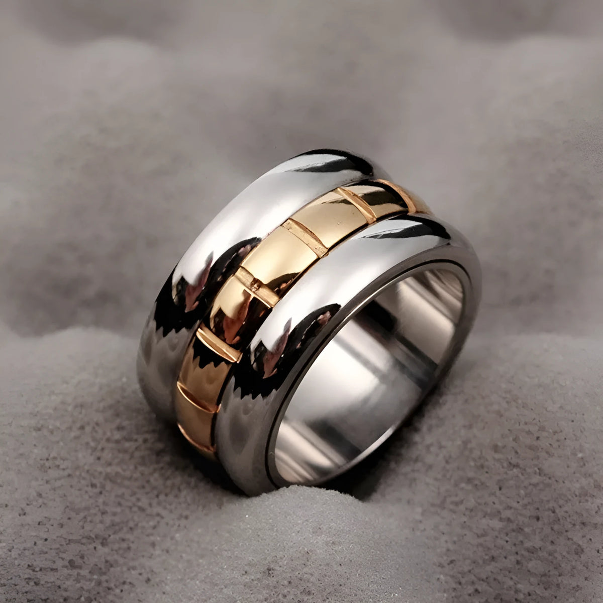Gold ultra-wide titanium steel men's ring with a rotatable tail component on a finger.