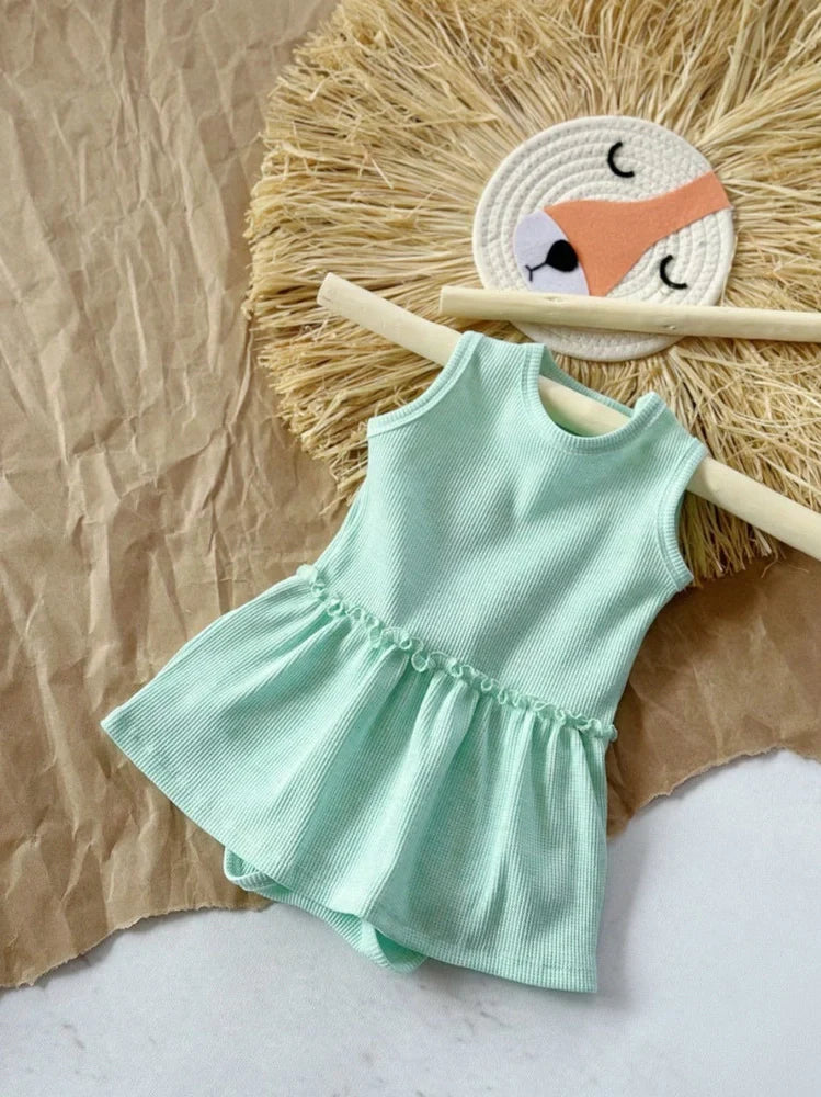 Baby girl wearing pink sleeveless vest onesie with waffle cotton texture and single-breasted closure