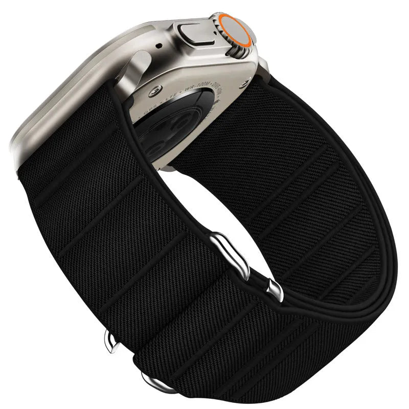 Elastic nylon Apple Watch band in Army Green with stainless steel buckle, shown on a wrist.