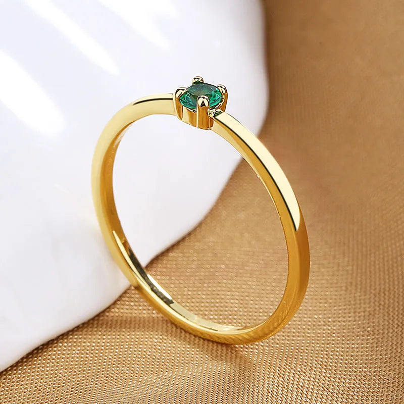 Twin Style copper geometric circle ring with a single diamond, shown in blue, green, red, or white.