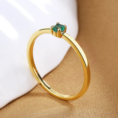 Twin Style copper geometric circle ring with a single diamond, shown in blue, green, red, or white.