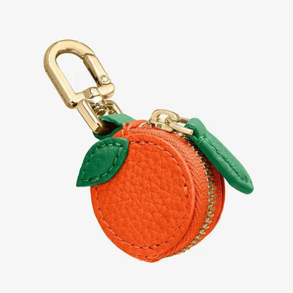 Small solid colour PU leather keychain coin bag in cherry, blueberry, or orange.