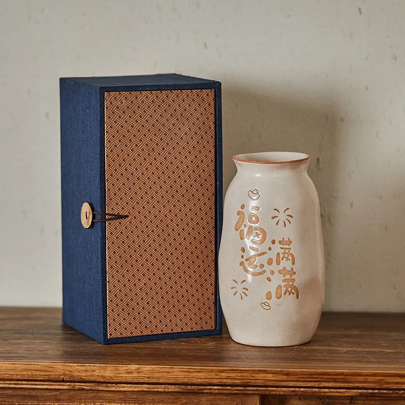 Hand-painted Chinese ceramic vase with carved detail on a desk, shown in Double Happiness colour design.