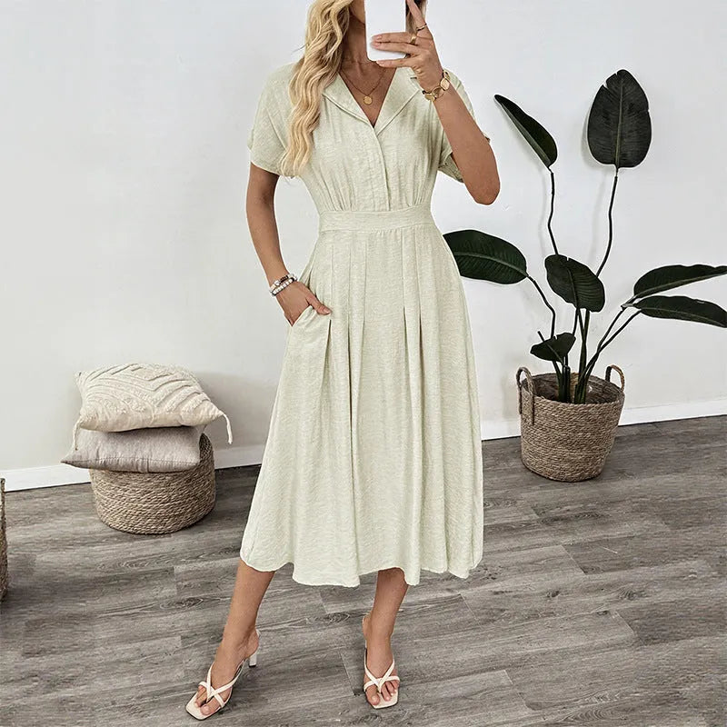 Light green women's shirt dress with lapel collar, waist tie, and pockets on a mannequin.