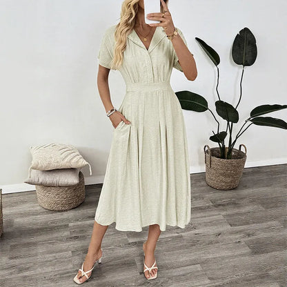 Light green women's shirt dress with lapel collar, waist tie, and pockets on a mannequin.