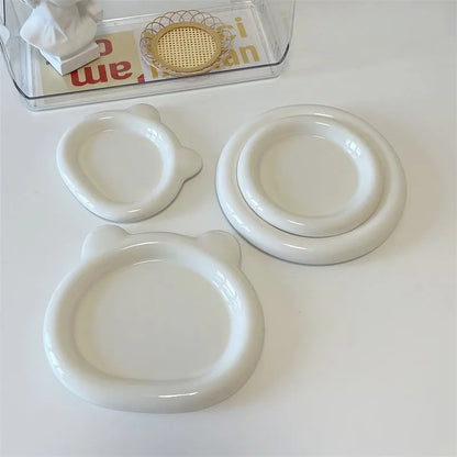 White porcelain plate with chubby toot bear design, shown in small 15cm and large 20cm sizes.