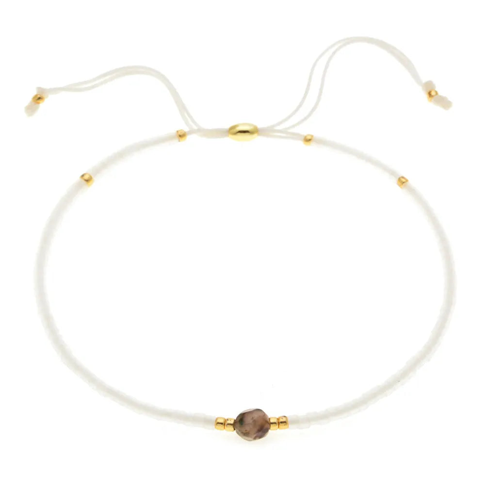 Handmade women's bracelet with colourful geometric glass and coloured glaze beads in Bohemian style.