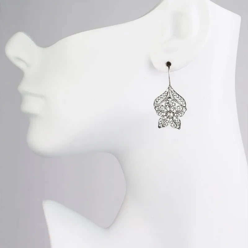 Silver hollow flower leaf-shaped alloy earrings with openwork floral detailing