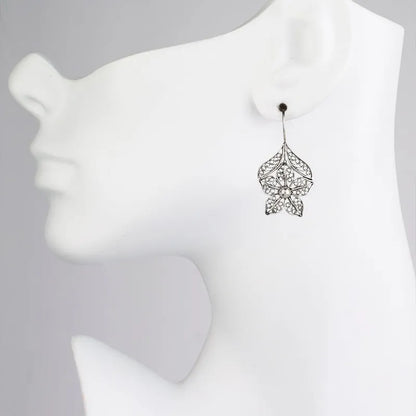 Silver hollow flower leaf-shaped alloy earrings with openwork floral detailing