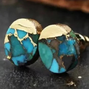 Handmade natural stone bohemian style stud earrings with an irregular organic shape on a grey background.