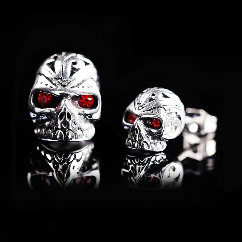 Red eye skull stud earrings with electroplated alloy construction and gemstone accents